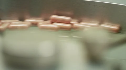 Capsule Counter Machine and Bottler Counting Vitamins In Factory Stock Footage 50033836