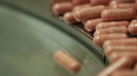 Capsule Counter Machine and Bottler Counting Vitamins In Factory Stock Footage 51341586