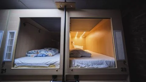 Capsule hotel beds providing comfortable and private accommodation Stock Photos