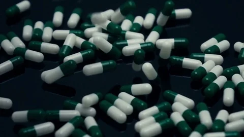 Capsule pills falling in slow motion 500fps Stock Footage 74753649