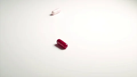Capsule tablet falling and bouncing Stock Footage 77644814