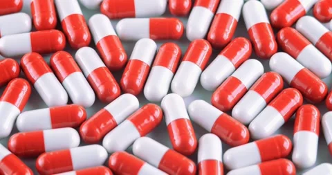 Capsule on a white background filled with medicine is in a chaotic order. Tablet Stock Footage 244007904