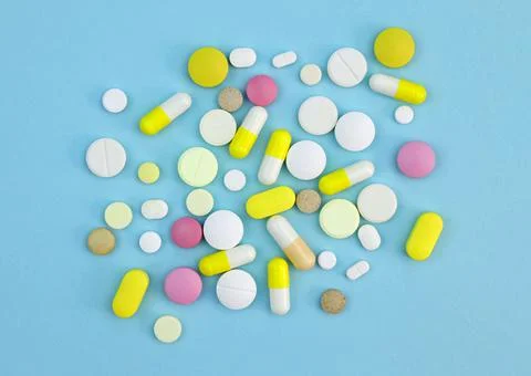 Capsules and tablets colored top view Stock Photos