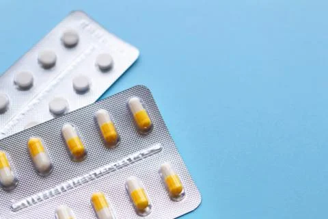 Capsules and tablets in packaging, space for text Stock Photos