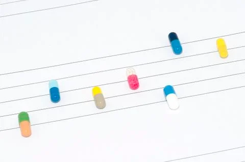 Capsules and tablets on stave Stock Photos