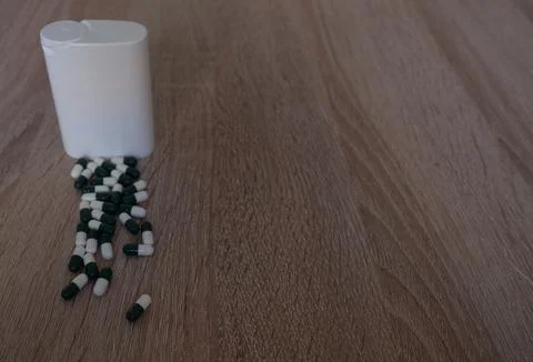 Capsules and White Container Stock Photos
