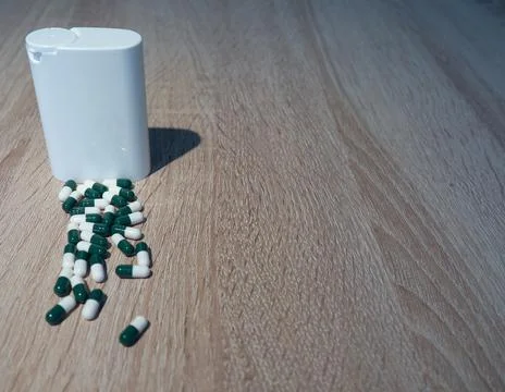 Capsules and White Container Stock Photos