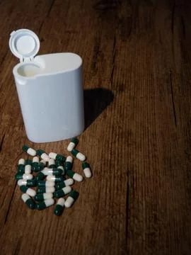 Capsules and White Container Stock Photos
