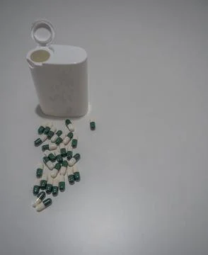 Capsules and White Container Stock Photos