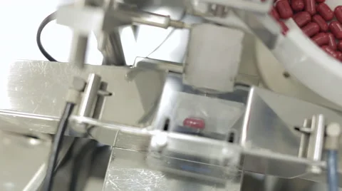 Capsules being Processed in Pill Sorting Machine Stock Footage 68641875