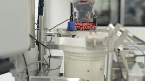 Capsules being Processed in Pill Sorting Machine Stock Footage 68642015