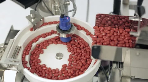Capsules being Processed in Pill Sorting Machine Stock Footage 68642092