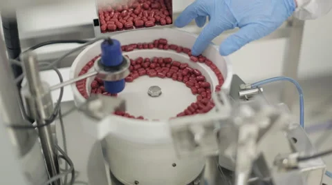 Capsules being Processed in Pill Sorting Machine Stock Footage 68642167