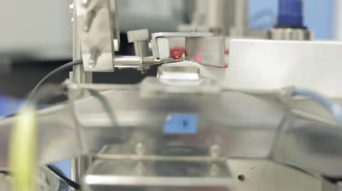Capsules being Processed in Pill Sorting Machine Stock Footage 68642172