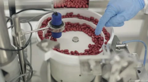 Capsules being Processed in Pill Sorting Machine Stock Footage 68642228