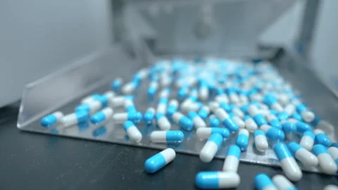 Capsules close up. pills moving on a machine. capsule pill making process in a p Stock-Footage 289574758