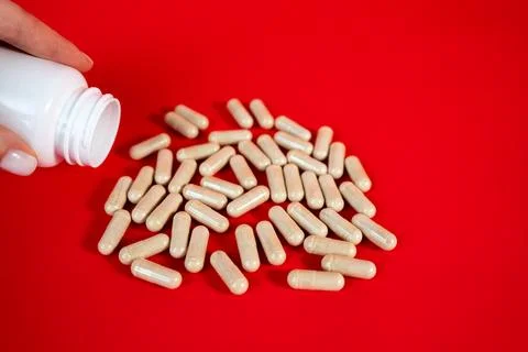 Capsules forming pile on red background Stock Photos