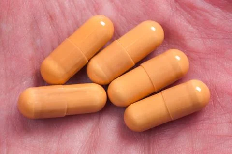 Capsules on hand Stock Photos