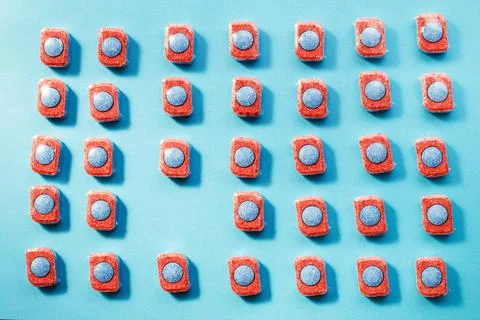 Capsules for kitchen dishwashers on a blue background. flat lay. 스톡 사진