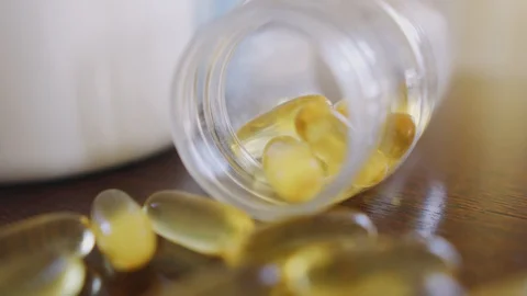 Capsules omega 3 close up on the table dolly shot using shallow depth of field Stock Footage 126570273