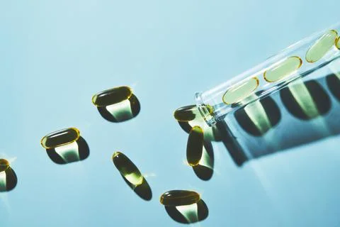 Capsules of omega-3 fatty acids on a blue Stock Photos