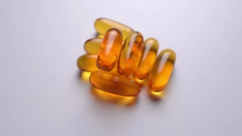 Capsules Omega 3 on white background. Cod liver oil capsules. Stock Footage 248338459