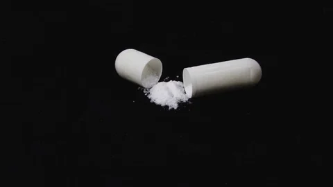 Capsules in the package rotate black background Stock Footage 107008705