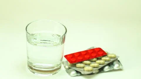 Capsules, pills, tablets on white table, top view. Stock Photos