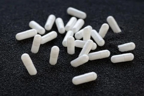 Capsules in sand Foto stock