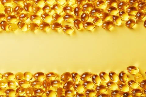 Capsules in a shell with liquid vitamin D3 on a yellow background and a place Foto stock