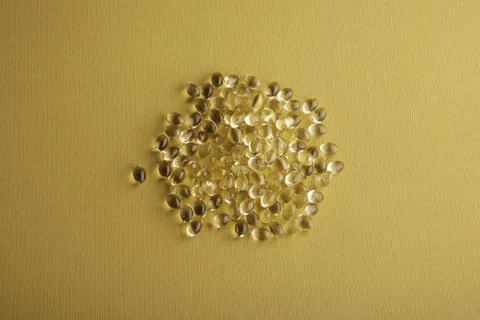 Capsules in a shell with liquid vitamin D3 on a yellow background Stock Photos