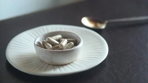Capsules in white plate Stock Footage 170962044