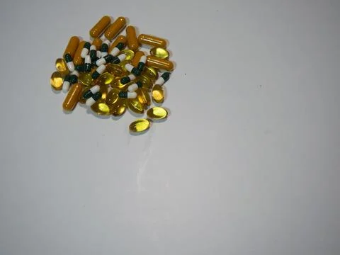Capsules on Wooden Surface Stock Photos