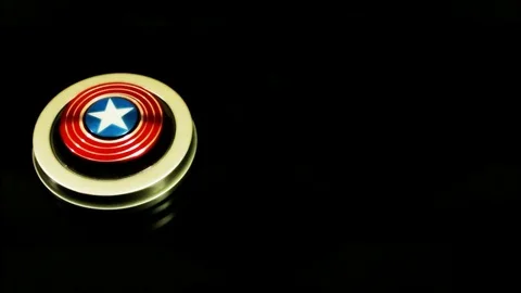 Captain america theme fidget spinner on black bg Stock Footage 79378098