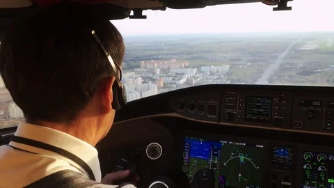 Captain in a cockpit operating the airplane 動画素材 77514228