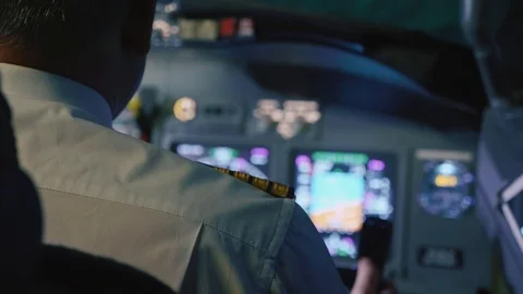 Captain is controls the airplane, rear view. Stock Footage 93349434