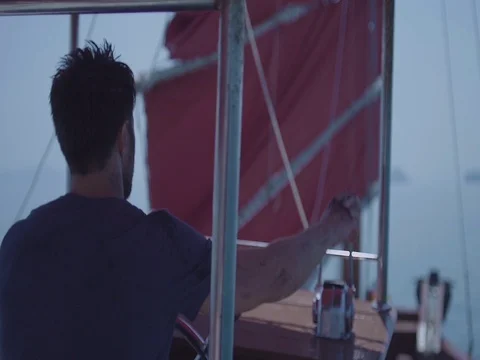 Captain on deck of large ship steering a wheel. Sailor at the helm of a sailboat Stock Footage 70153154