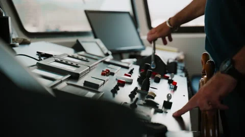 Captain hand operating throttle levers on a ferry bridge console to Amalfi Stock Footage 344734366