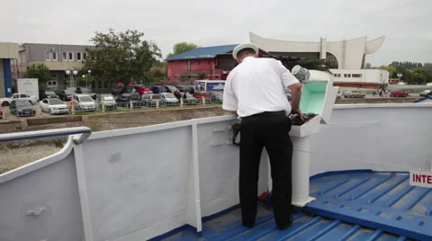 Captain at helm on deck pulling into harbor Stock Footage 55107280