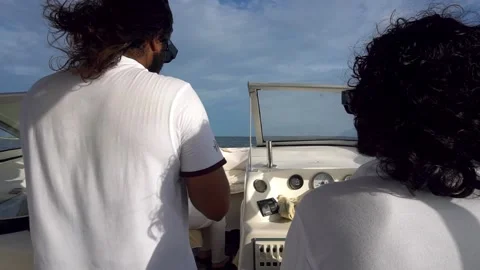 The captain at the helm of a high-speed boat Stock Footage 294688864