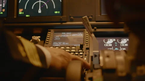 Captain inserting destination coordinates on cabin dashboard Stock Footage 205333370