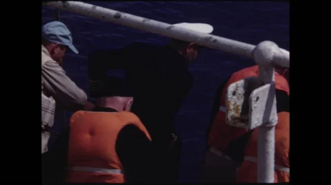 Captain looks Over Edge of Ship Stock Footage 47644405