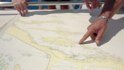 Captain planning the route on a map | Stock Video | Pond5