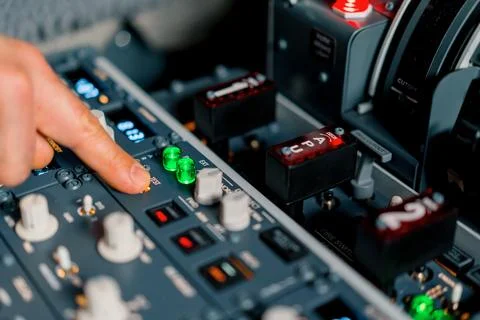 The captain presses the buttons on the control panel to start the engine of the Stock Photos