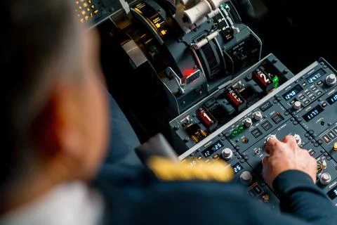The captain presses the buttons on the control panel to start the engine of the Stock Photos