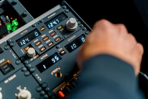 The captain presses the buttons on the control panel to start the engine of the Stock Photos