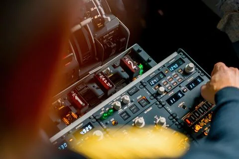 The captain presses the buttons on the control panel to start the engine of the Stock Photos