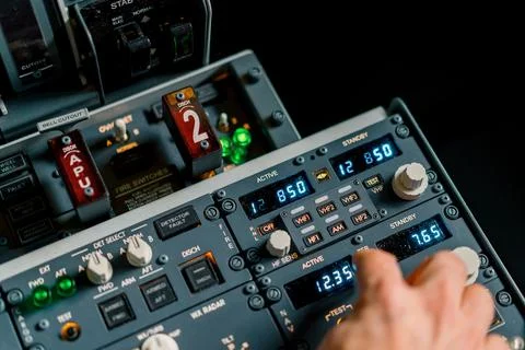 The captain presses the buttons on the control panel to start the engine of the Stock Photos