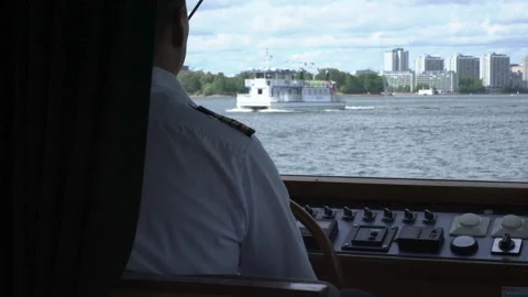 Captain sails a ship seeing a ferry ahead, over the shoulder shot Stock Footage 236002026