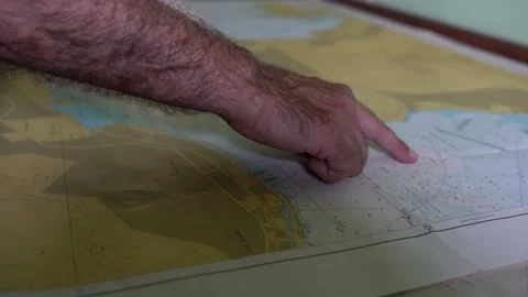 Captain shows the navigation on a nautical map 4k Stock Footage 201034303